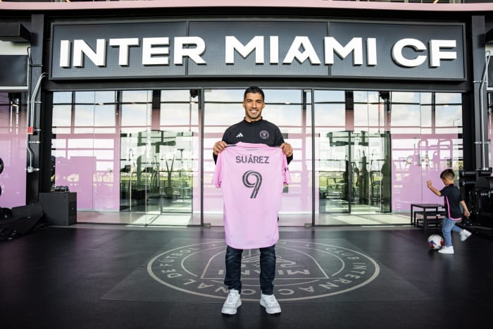 Luis Suarez pictured holding an Inter Miami jersey after signing for the Major League Soccer club ahead of the 2024 season